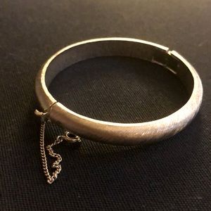 Vintage Crown Trifari textured silver-tone hinged bangle bracelet.